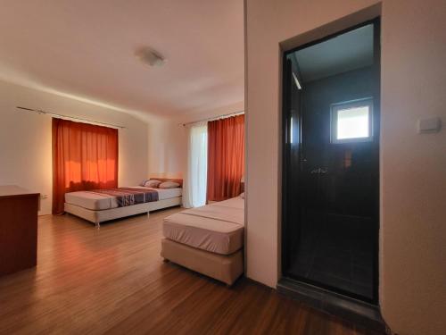 a hotel room with two beds and a large window at Apartment N.1 in Nov Dojran