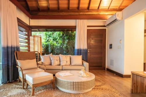 a living room with a couch and a table at Pousada Morena in Fernando de Noronha