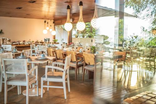 a restaurant with tables and chairs in a room at Pousada Morena in Fernando de Noronha