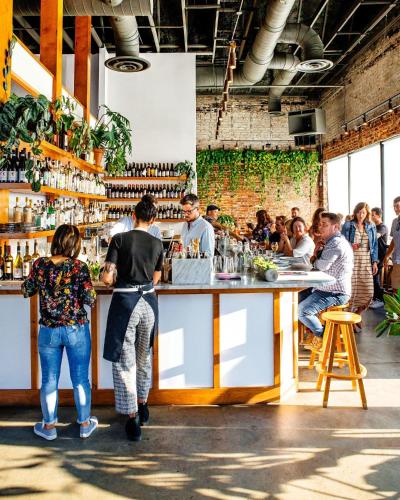 a group of people standing at a bar at Abode Nashville - Germantown in Nashville