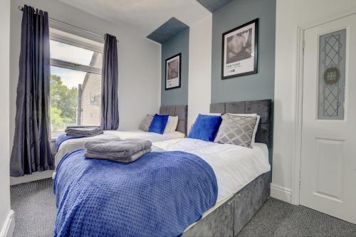 a bedroom with two beds and a window at A Gem in Central Hull - Sleeps 6 in Hull