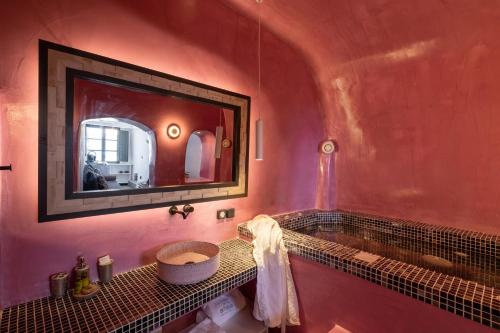 a bathroom with a sink and a mirror at Amaya Selection of Villas in Oia
