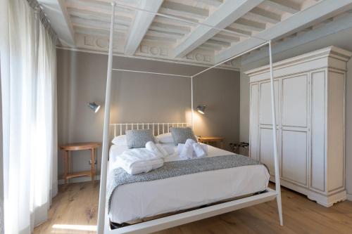 a bedroom with a white canopy bed with white pillows at Anima di Vinci in Vinci
