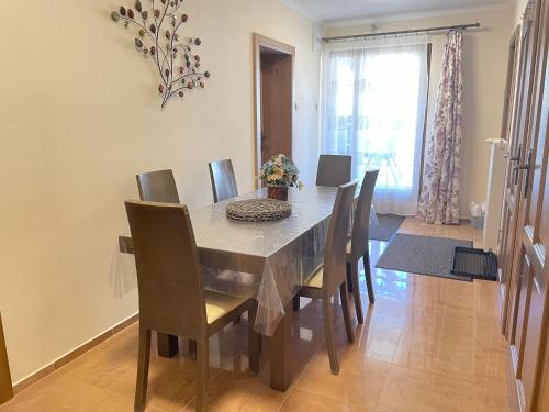 a dining room with a table and chairs and a window at Chalupa pod Tatrami in Liptovská Teplička