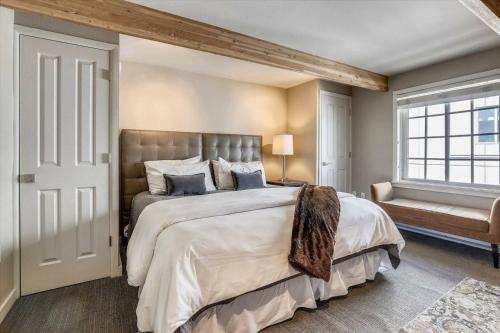 a bedroom with a large bed and a window at Downtown Aspen 2 Bedroom Condo in Aspen