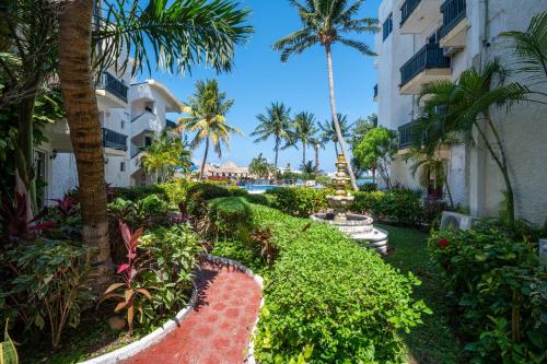 a view of a resort with palm trees and plants at Hotel Imperial Laguna Faranda Cancún in Cancún