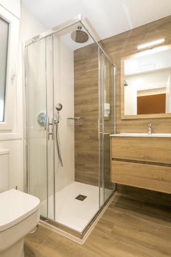 a bathroom with a shower and a toilet and a sink at Palacios 30, Playa Nanín in Sanxenxo