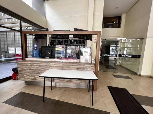 a bench in the middle of a store lobby at Apartamentos Bulnes in Santiago