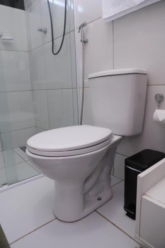a white bathroom with a toilet and a shower at Edícula Próxima a Praias! in São Luís