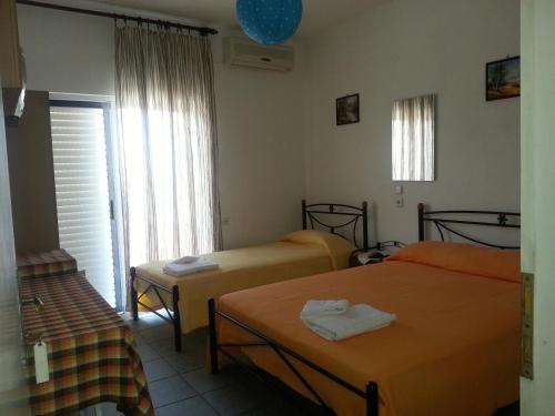 A bed or beds in a room at Efstathiou Mihail Studios and Apartments