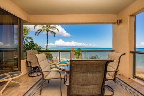 a dining room with a view of the ocean at Sands Of Kahana 315 2Bd 2Ba Oceanfront condo in Kahana