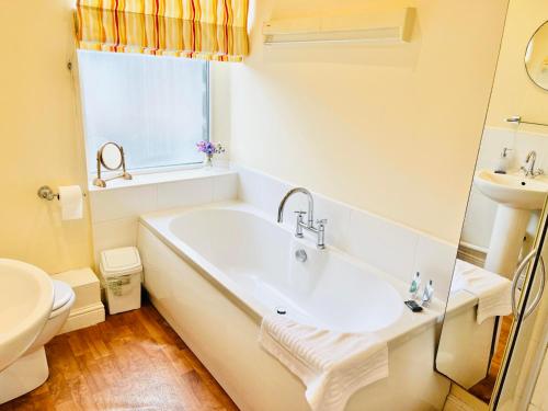 a bathroom with a tub and a sink at Skipton Cottage in Skipton