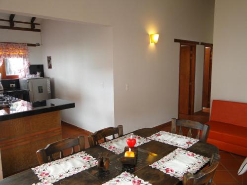 a dining room with a table and a kitchen at Cabañas Villa Encanto in Villa de Leyva