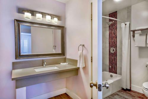 a bathroom with a sink and a mirror and a shower at Motel 6-Inglewood, CA in Inglewood