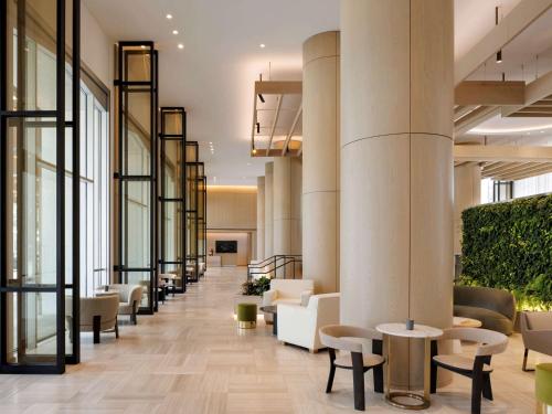 a lobby with chairs and tables in a building at Fairmont Century Plaza Los Angeles in Los Angeles