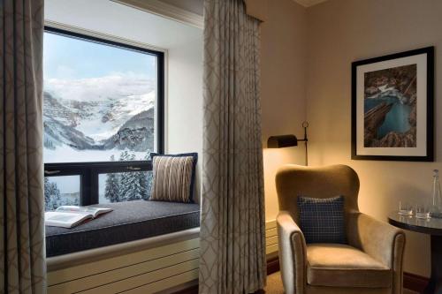 a window seat in a room with a view of a mountain at Fairmont Château Lake Louise in Lake Louise