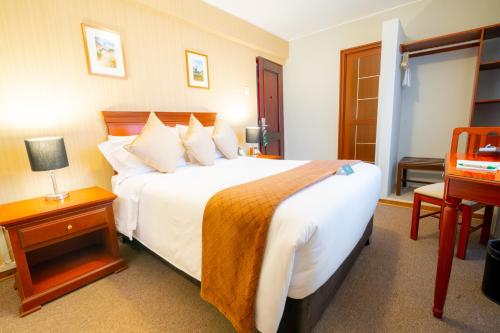 Ένα ή περισσότερα κρεβάτια σε δωμάτιο στο El Tumi Hotel