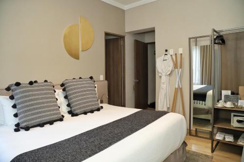 a bedroom with a large bed with two pillows at Agata Hotel Boutique & Spa in Mexico City