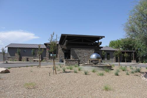 a building with a fountain in the middle of a yard at Verde Ranch RV Resort in Camp Verde