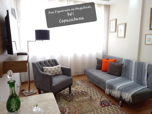 a living room with a couch and two chairs and a table at Copacabana Beach Modern Apartments in Rio de Janeiro