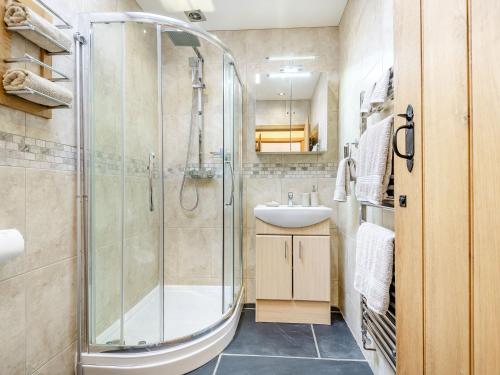 a bathroom with a shower and a sink at The Granary in Llanfair Caereinion