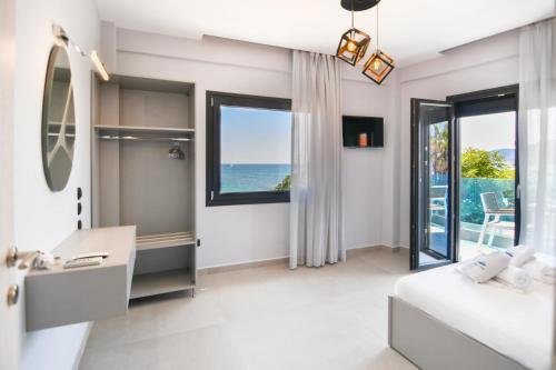 a bedroom with a bed and a sink and a window at Athos Veranda in Sarti