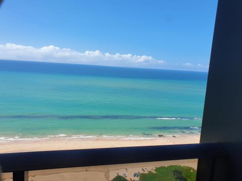 an ocean view from a window of a beach at Flat Beach Class Internacional in Recife