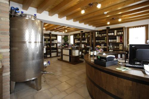 a large room with a bar with a water boiler at Le Favole Agriturismo in Sacile