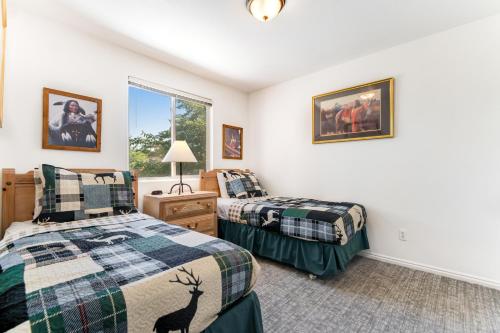 a bedroom with two beds and a window at Solano Vallejo 3288 in Moab