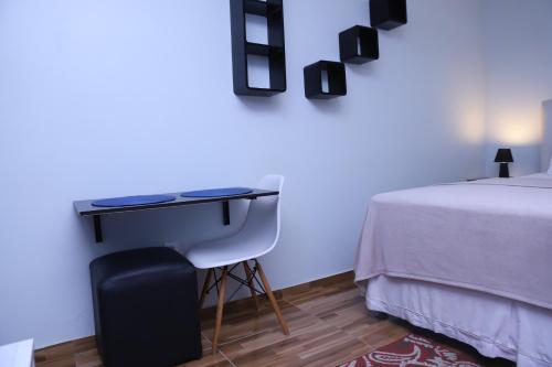 a bedroom with a desk next to a bed at Edícula Próxima a Praias! in São Luís