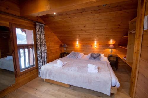 a bedroom with a large bed in a cabin at Chalet Clearmount with Spa in Méribel