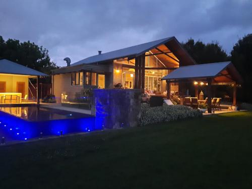 a large house with a swimming pool in front of it at Belvoir Pavilions near Berry in Berry