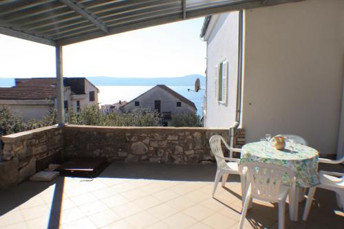 a patio with a table and chairs on a balcony at Apartments with a parking space Sveti Petar, Biograd - 3251 in Sveti Filip i Jakov