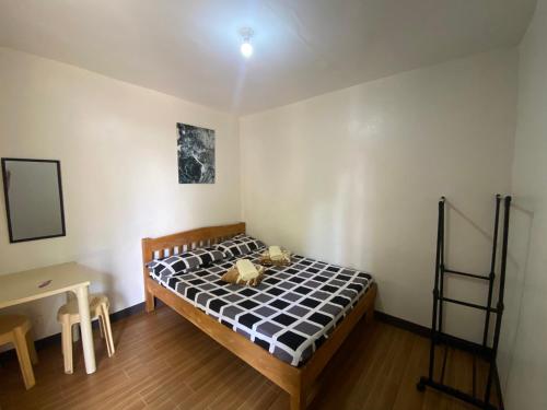 a bedroom with a bed with a teddy bear on it at Alona Bohol Backpackers Hostel in Panglao