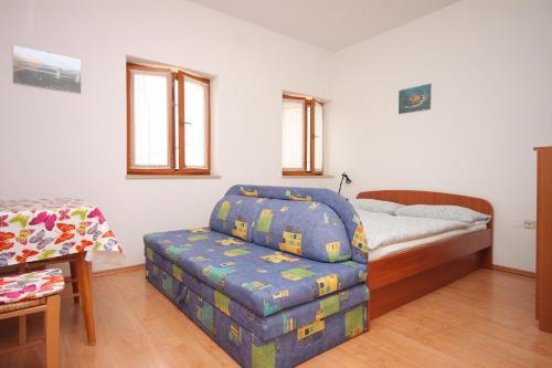a bedroom with a bed and a futon and a table at Apartments with parking space Kraj, Opatija - 7794 in Kraj