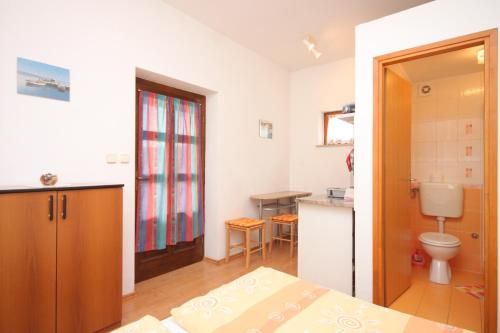 a bathroom with a bed and a sink and a toilet at Studio Kraj 7794b in Kraj