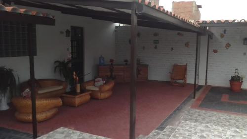 a room with couches and chairs in a building at La Posada in Pimentel