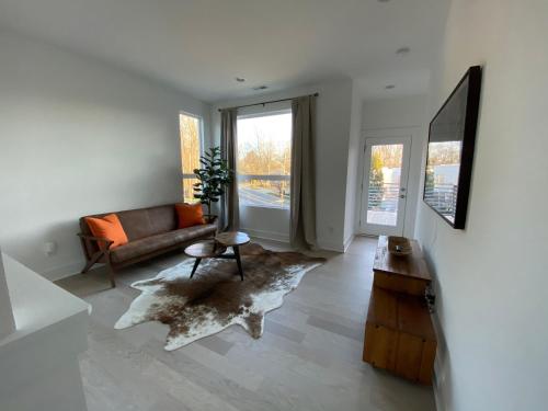 a living room with a couch and a table at Entire Home Close to BOA Stadium & City in Charlotte