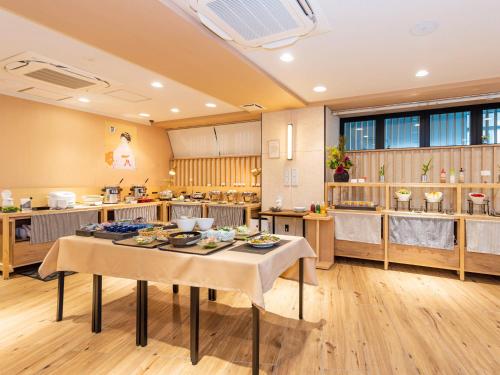 a large kitchen with a table with food on it at ホテルアベストグランデ京都清水 in Kyoto