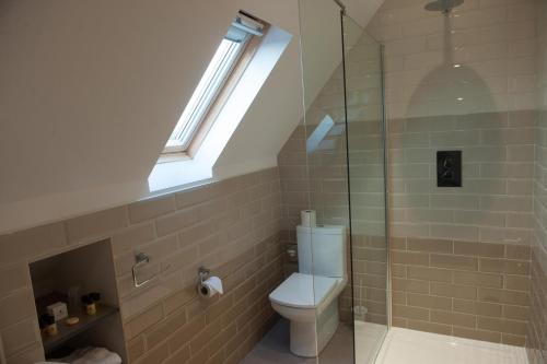 a bathroom with a toilet and a skylight at Hotel Forty One in Great Driffield