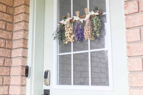 a door with a window with a wreath on it at Family-Friendly Boho Stay - Sleeps 10 - Near the Falls in Thorold