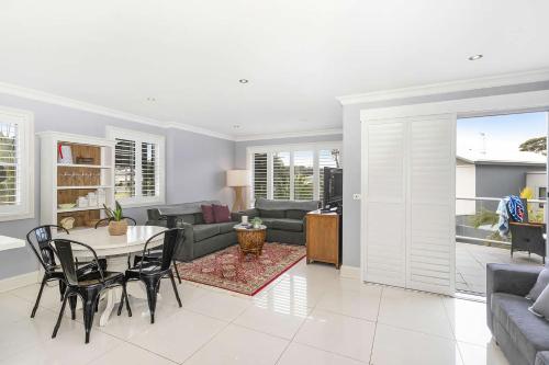 a living room with a table and chairs at North Harbour in Ulladulla