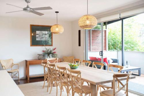 a dining room with a table and chairs at Aurora in Mollymook