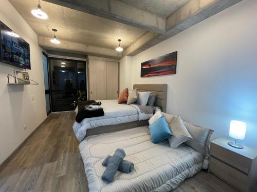 a living room with two beds and a couch at St. Louis Suites - Movistar Arena in Bogotá