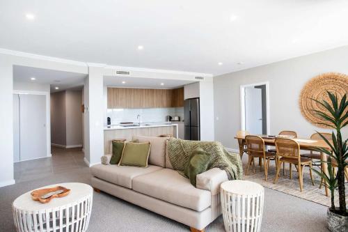 a living room with a couch and a table at Marina View in Ulladulla