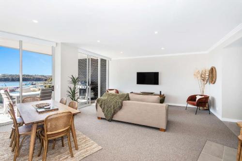 a living room with a couch and a table at Marina View in Ulladulla