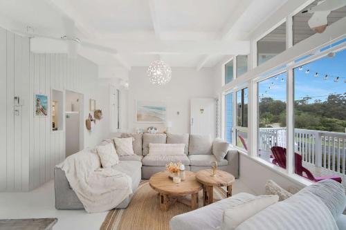 a living room with a couch and a table at Miss Mollymook in Mollymook
