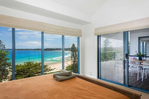 a bedroom with a view of the ocean at Northstar on Mollymook Beach in Mollymook