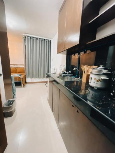 a kitchen with a sink and a counter top at Sto Niño Residences Lucena City in Lucena