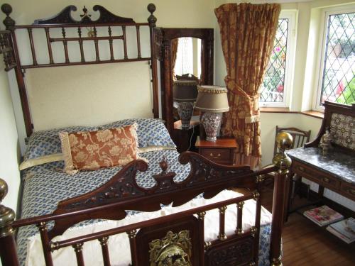 a bedroom with a bed, a chair, and a window at Killyon Guest House in Navan